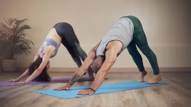 Couple doing Downward Facing Dog Yoga Asana